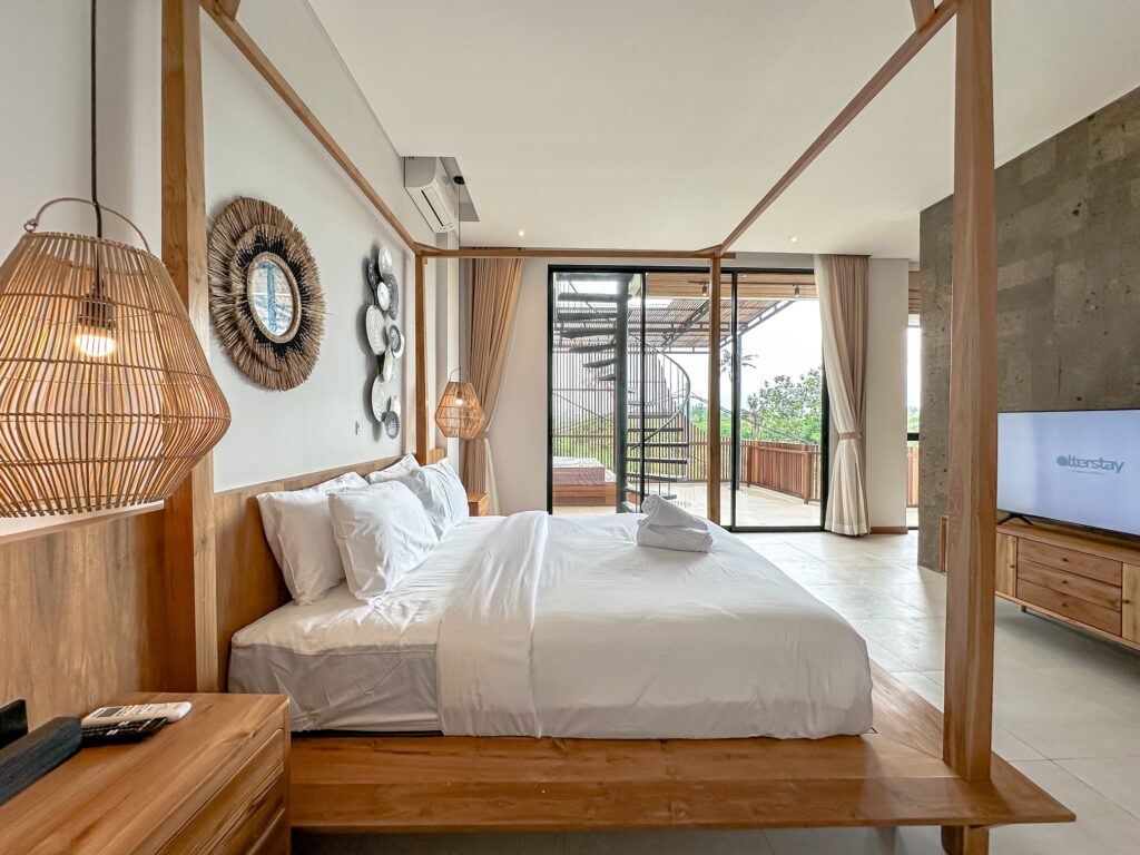 a bed with a wood post and a glass door